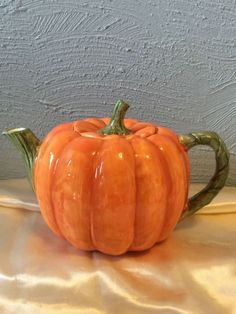 an orange pumpkin sitting on top of a table