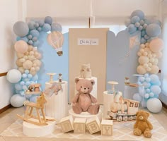 a baby's room decorated with balloons and teddy bears