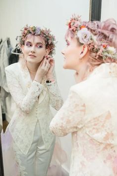 a woman is looking at herself in the mirror