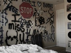 a bedroom with graffiti all over the walls