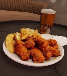 chicken wings and chips on a plate next to a glass of beer