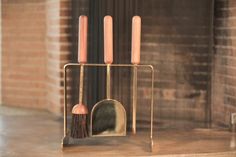 a candle holder with three candles and a brush