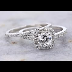 an engagement ring with a cushion cut diamond surrounded by pave set diamonds