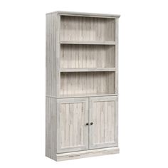 a white bookcase with two doors and drawers