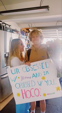 two children holding up a sign that says ur obsesed