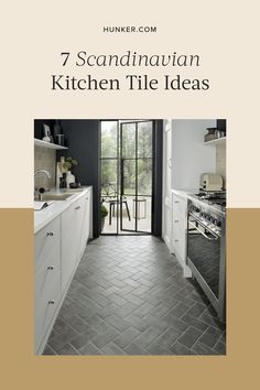 a kitchen with tile flooring and white cabinets in front of an open glass door