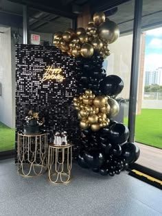 black and gold balloons are on display in an office