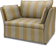 a yellow and white striped chair with two pillows on top of it's arm