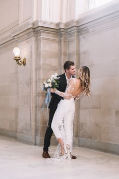 a bride and groom are standing in the lobby