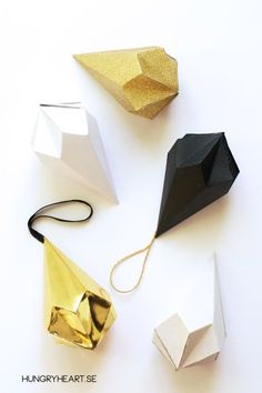 four different types of origami shapes on a white surface