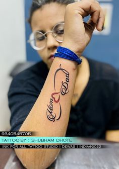 a woman with a tattoo on her arm is holding up the word love in two languages