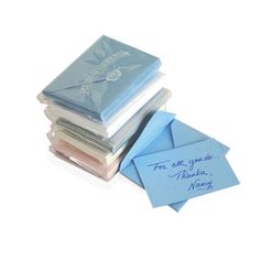 a stack of folded cards and envelopes sitting on top of each other