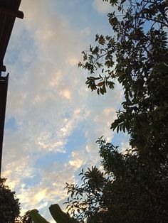 the sky is filled with clouds and trees