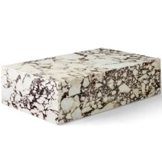 a white and brown marble box sitting on top of a table