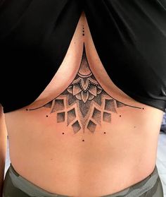 a woman's lower back with an intricate design on her stomach and the bottom part of her body