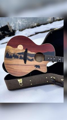 an acoustic guitar is sitting in the snow with its case open and it's ready to be played