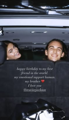 two people sitting in the back of a car with a happy birthday message on it