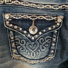 the back pocket of a pair of jeans with an embellished design on it