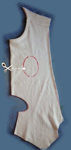 a piece of cloth with scissors and thread attached to the back of an unbuttoned vest