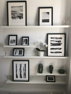 some white shelves with black and white pictures on them