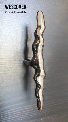 a door handle on a wooden door with metal paint and wood grained finish to it