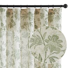 a curtain with green and white flowers on it, next to a black roddle