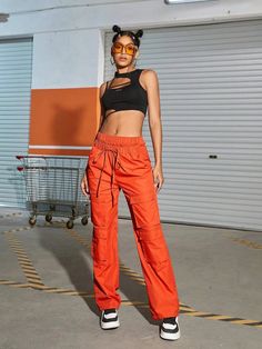 Make a bold fashion statement with these Orange Waist Flap Pocket Cargo Pants. Their plain pattern and high waistline add a touch of sophistication to your casual look. The drawstring waist ensures a comfortable fit, while the non-stretch fabric offers durability. These long-length pants are ideal for any occasion, and the waist flap pockets add a trendy twist. Details: Color: Orange Style: Casual Pattern Type: Plain Type: Cargo Pants Closure Type: Drawstring Waist Waist Line: High Waist Length: High Waist Drawstring Athleisure Pants, Sporty High-waisted Cargo Pants For Spring, Spring Athleisure Cargo Pants With Drawstring, Sporty Orange Bottoms With Drawstring, Chic High Waist Parachute Pants For Streetwear, Sporty High Waist Pants With Drawstring, Sporty High Waist Drawstring Pants, Sporty High-waist Drawstring Pants, Urban Style Summer Cargo Pants With Elastic Waistband