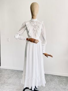 "GUNNE SAX WHITE COTTON GAUZE DRESS Circa 1970s, highly rare and collectible Perfect for a bohemian bride Soft, angelic white cotton gauze Fully lined with subtle sheerness Lace detail adorns bodice and neckline Maxi length skirt with ruffle trim  Full zip closure down back Long sleeves with button closure at wrists Incredible vintage condition, structurally sound and wearable as is. Due to age and delicate nature of fabric, some standard signs of wear are to be expected. No major flaws to note! Tagged size 3 Bust flat 17\" Waist flat 11.5\" Shoulders across 15\" Sleeve length 19\" Full length 51\" 2 business day handling time, USPS Priority Mail is standard. International shipping available! Buyer is responsible for shipping costs. ALL ITEMS SOLD AS IS. Due to the delicate nature of pre l White Floor-length Victorian Dress With Ruffles, White Fitted Vintage Victorian Dress, White Fitted Victorian Dress Floor-length, White Victorian Style Dress, Vintage Fitted White Prairie Dress, Fitted Vintage White Prairie Dress, Fitted White Vintage Prairie Dress, White Fitted Victorian Prairie Dress, White Victorian Prairie Dress For Wedding