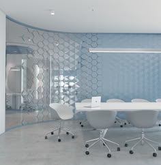 a white table and chairs in a room with blue wallpaper on the back walls