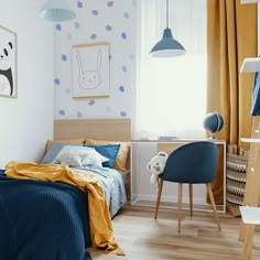 a child's bedroom with blue and yellow decor on the walls, wood flooring and bed