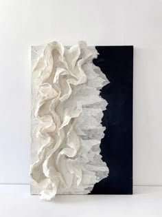 an abstract painting with white and blue colors on the canvas, it looks like something out of