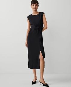 Elevate your wardrobe with the Ann Taylor Petite Knit Belted Column Maxi Dress, a testament to understated elegance. This dress is designed to make a statement with its sleek silhouette and sophisticated details.

- **Size:** Petite 16
- **Color:** Black
- **Material:** Shell: 95% Polyester, 5% Spandex; Lining: 100% Polyester
- **Gender:** Female
- **Features:** Crew neck, cap sleeves, self-tie belt, front slit, hidden back zipper with hook-and-eye closure, lined bodice
- **Length:** 29" from na Petite Knit, Belted Maxi Dress, Petite Maxi Dress, Ann Taylor Petite, Elegant Black Dress, Petite Fashion, Petite Dresses, Tie Belt, Belted Dress