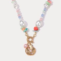 Bring the joy of summer to your wardrobe with our Sea Shell Pearl Necklace! Channel your inner mermaid with this necklace, featuring an assortment of sea shells, ceramic beads, and freshwater pearls., which will surely light up your eyes and add a cheerful touch to any outfit. Embrace the beauty of the sea and add a touch of whimsy to your style. DETAILS Plating: 18K Gold on Alloy Materials: Alloy, ABS Pearl, Shell, Cubic Zirconia Measurements: Length: 16.9"(43cm) Weight: 24g Everyday Wear Jewelry, Astrology Jewelry, Astrology Necklace, Moon And Star Ring, Moon And Star Earrings, Nature Earrings, Nature Necklace, Jewelry Lockets, Summer Necklace