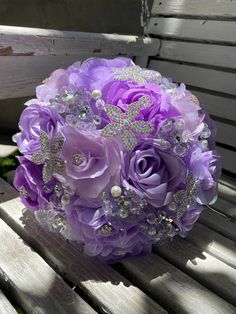 a bridal bouquet sitting on top of a wooden bench