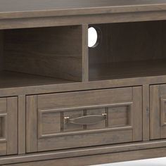 an entertainment center with two drawers and one door open on the bottom shelf is shown