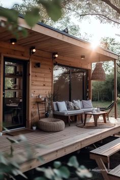 a wooden deck with furniture on top of it and trees in the backgroud