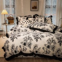 a bed with black and white flowers on it