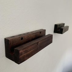 two pieces of wood are hanging on the wall