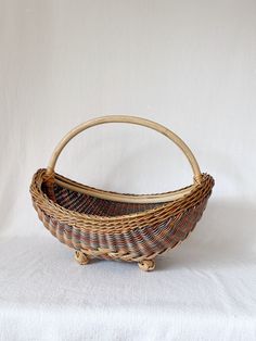 a wicker basket sitting on top of a white cloth