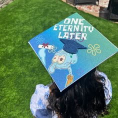 a person wearing a blue graduation cap with an octopus on it's side and the words, one eternity later