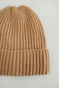 This beanie features a ribbed, knitted design, a cozy, warm material and a folded over design. Circumference: 50 cm / 19.6 in. Height: 21 cm / 8.2 in. Cozy Knitted Beige Bonnet, Cozy Soft Knit Beige Bonnet, Cozy Beige Soft Knit Bonnet, Cozy Beige Knit Crochet Hat, Cozy Beige Crochet Knit Hat, Beige Soft Knit Hat, Cozy Beige Beanie Cap, Beige Knit Beanie, Cozy Beige Crochet Beanie Hat