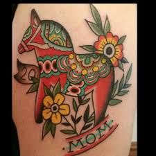 a colorful tattoo design on the back of a woman's thigh with flowers and an animal