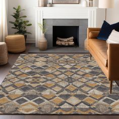 a living room with a couch, fireplace and rugs on the floor in front of it