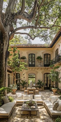 an outdoor living area with couches and tables