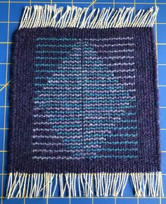 a blue and white rug sitting on top of a cutting board