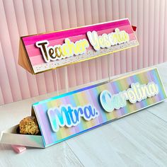 there are two candy boxes that say teacher victoria and mtra, along with a cookie in the box