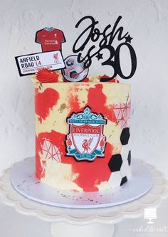 a red and yellow birthday cake with the number 30 on it's top tier