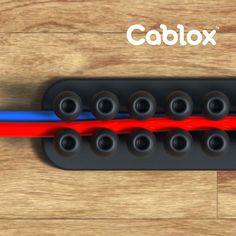 a close up of an electric guitar bridge on a wooden surface with the caption cablox