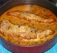 two sausages are being cooked in a sauce