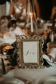 the table is set with an ornate frame and silverware